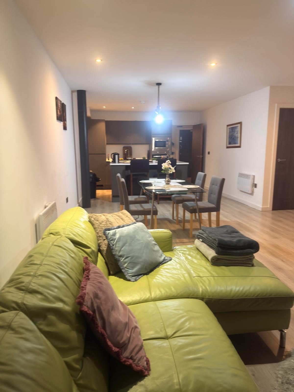 Corporate serviced apartment — open-plan lounge with open kitchen